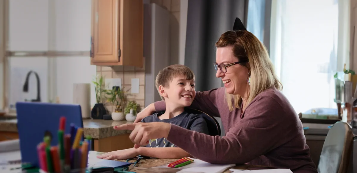 Student with his mom doing homework